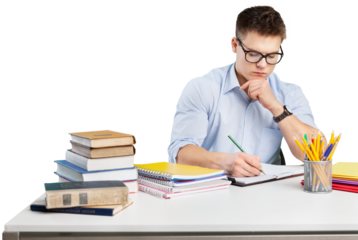 Young adult surrounded with piles of books and notebooks is writing in notebook