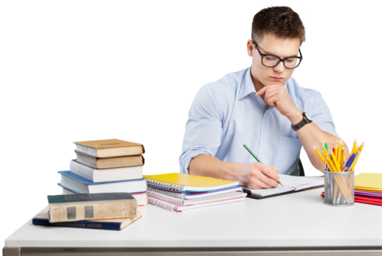 Young adult surrounded with piles of books and notebooks is writing in notebook