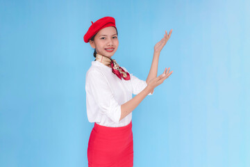A flight attendant or stewardess guiding people to the left side. A hostess presenting the storage...