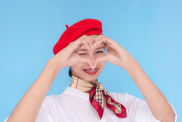 A flight attendant or stewardess showing affection and love. A hostess making a heart shape with...
