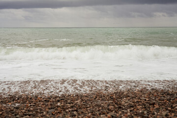 seashore with rocky beach in storm