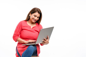 Young indian woman using laptop on white background.