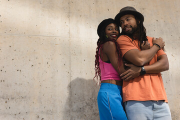 Portrait of African-American couple embracing each other..