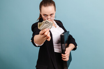 Woman with angry face holding out her hand with money