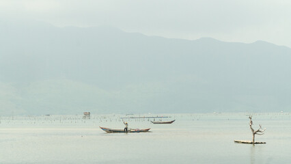 Fishing boat, snag, river and sky one background
