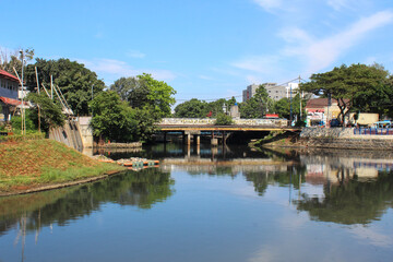 Obraz premium clean urban river with green grass on the banks