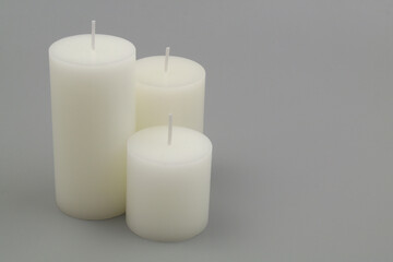 Fototapeta na wymiar New scented candles on gray background. Space for text.