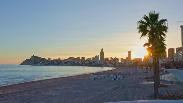 sunset on the beach over the city benidorm