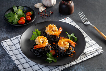 Squid ink spaghetti with shrimp on the table