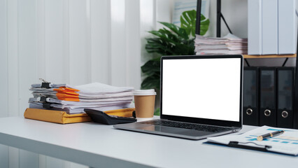 Stylish workspace with laptop, notebook, blank screen laptop on white table of bookkeeping.