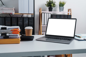 Fototapeta premium Stylish workspace with laptop, notebook, blank screen laptop on white table of bookkeeping.