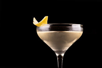 Glass of Agent 007's Special Vesper Cocktail with Orange Peel Garnish close-up on the rim of the...