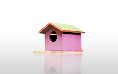 Wooden sweet pink birdhouse isolated on white background with reflection, clipping path included.