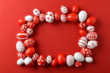 Easter backgrounds with a rectangular frame of Easter red and white eggs on a bright red background. A place to copy. Flat position, top view.