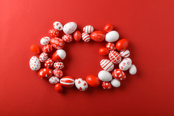 Easter backgrounds with a square frame of Easter red and white eggs on a bright red background. A place to copy. Flat position, top view.