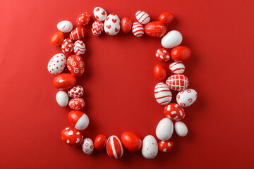 Easter backgrounds with a rectangular frame of Easter red and white eggs on a bright red background. A place to copy. Flat position, top view.