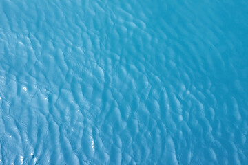 Blue Sea surface aerial view with waves from a drone, empty blank to background. soft focus.