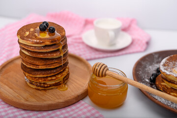 pancakes with honey for breakfast. delicious food.