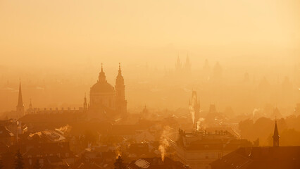 Obraz premium Prague cityscape in morning light. Towers of Lesser Town in autumn fog, Czech Republic..