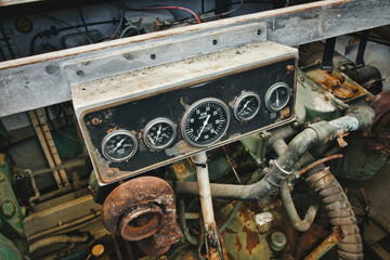 Dial gauge dashboard of a diesel engine in a engine room of a boat showing RPM and other...