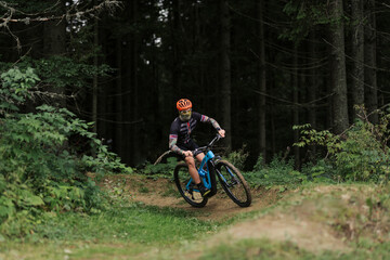 Cyclist Riding the Bike in the Beautiful Mountains Down the Rock on Background. Extreme Sport and Enduro Biking Concept