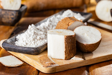 pile of cassava, cassava and cassava flour on a background of rustic wood (Manihot esculenta)
