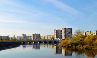 Fototapeta na wymiar Panorama of the city in autumn. River and bridge and residential high-rise buildings