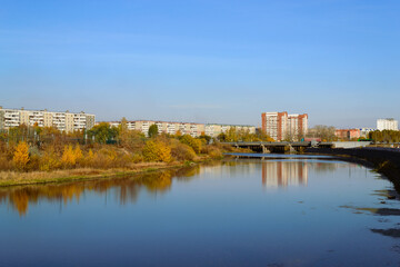 Panorama of the city in autumn. River and bridge and residential high-rise buildings