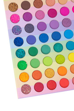 Multicolored neon eyeshadow palette. Make-up. Beauty products. Bright colorful beautiful background. Tool for makeup artist. Cosmetic. Visagiste. Beauty shop. Summer eye shadow.