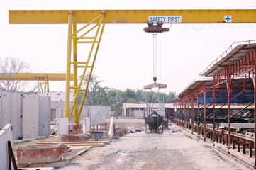 Crane lifting cement at construction site.