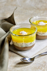 Homemade layered vegan dessert of baked coconut cream and chocolate marble stone board