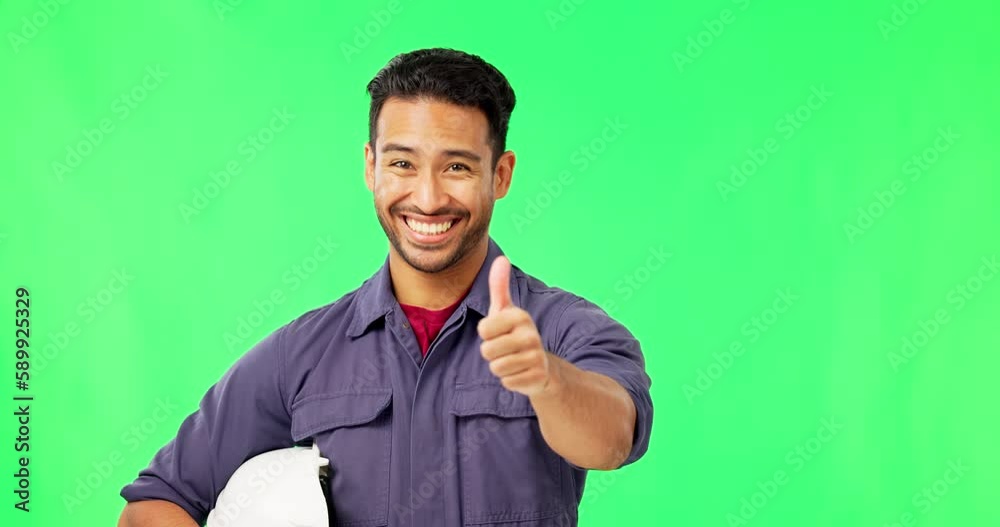 Wall mural Asian man, engineer and thumbs up on green screen for success or good job against a studio background. Portrait of happy male technician smiling and showing thumb emoji, yes sign or like on mockup