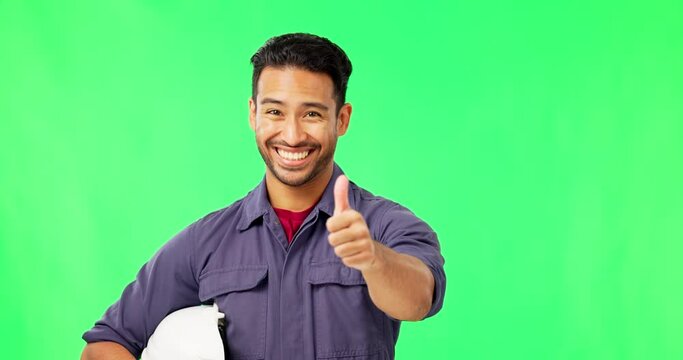 Asian man, engineer and thumbs up on green screen for success or good job against a studio background. Portrait of happy male technician smiling and showing thumb emoji, yes sign or like on mockup
