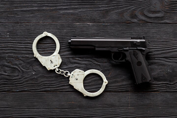 Hand gun weapon with handcuffs. Arrest of a criminal concept