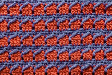 Orange blue seamless knitted texture. Cross over stitch pattern. Volumetric crochet striped...