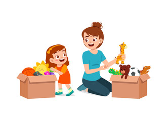 little kid put toys to box for donation with mother