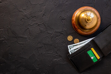 Hotel payment concept with vintage hotel service bell and wallet