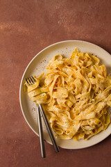 Fettuccine, tagliatelle, in creamy garlic sauce, Italian traditional cuisine, pasta carbonaro,