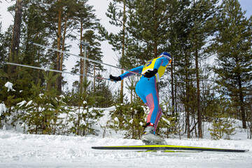 male athlete skier running cross country skiing in skating style, winter sports competition