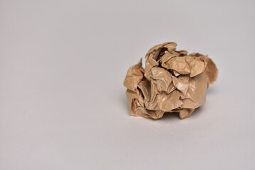 Crumpled brown paper on a white background. concept of disappointment, failure