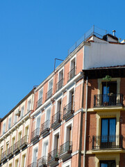 Obraz premium Classy elegant corner of the colourful building downtown Madrid, Spain. Vertical photo with copy space