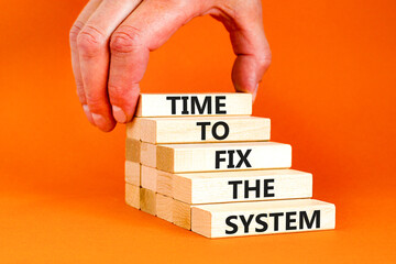 Time to fix the system symbol. Concept words Time to fix the system on wooden block. Beautiful orange table orange background. Businessman hand. Business and time to fix the system concept. Copy space