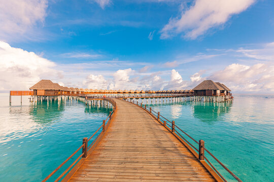 Amazing tranquil travel Maldives island, luxury over water villas pier resort. Beautiful sunny sky sea bay lagoon beach background. Summer vacation holiday. Paradise shore exotic  pristine landscape