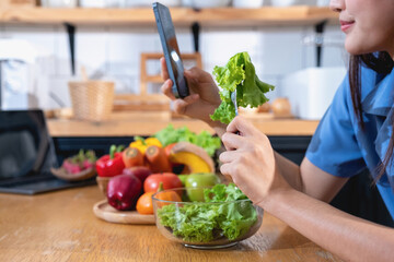 Diet, white-skinned young Asian woman in a blue shirt eating vegetable salad and apples as a healthy diet, opting for junk food. Female nutritionist losing weight. healthy eating concept.