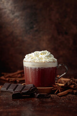 Hot chocolate with ingredients on a brown table.