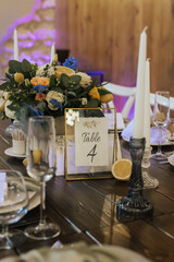 Preparing for wedding in Tuscany style. Decorated served wooden tables await guests. Decoration details. 