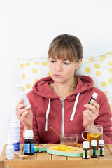 Young woman hesitating between industrial or natural medical treatments.