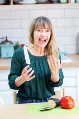 Young woman cutting her finger with a kitchen knife.