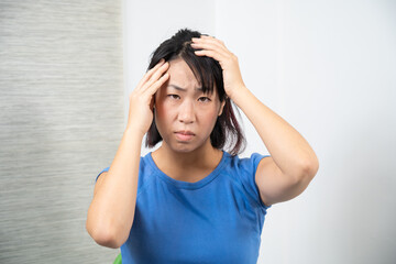 Asian woman having headache. Migraine