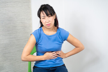 Asian woman having heartburn. Medicine